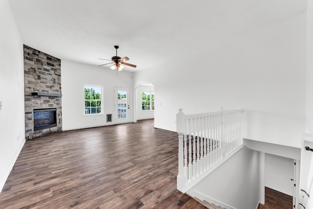 639 N Althea Ave, Nixa, MO 65714 - unfurnished living room featuring a ceiling fan, wood finished floors, arched walkways, and a fireplace
