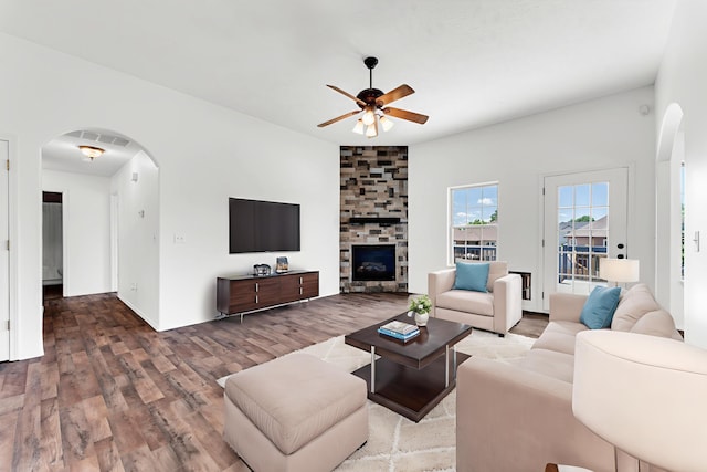 639 N Althea Ave, Nixa, MO 65714 - living area with arched walkways, a ceiling fan, wood finished floors, and a fireplace