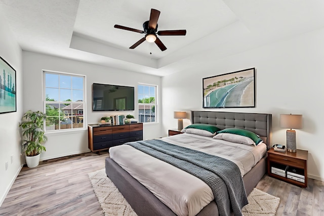 639 N Althea Ave, Nixa, MO 65714 - bedroom with a raised ceiling, light wood finished floors, and a ceiling fan