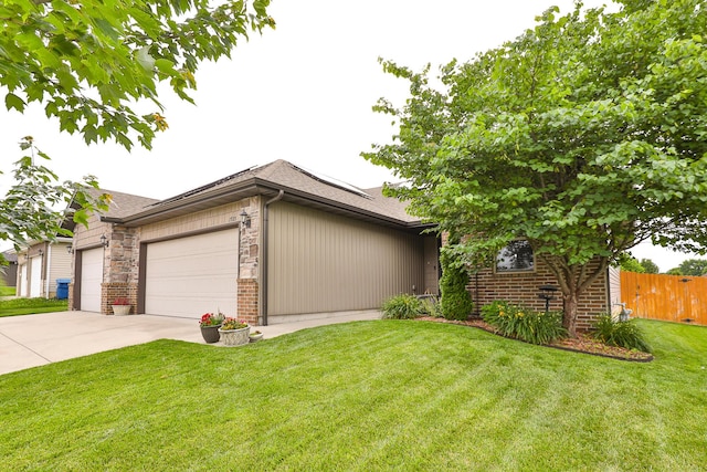 1925 E Costa Mesa Ct, Ozark, MO 65721 - view of front of home featuring a garage, roof mounted solar panels, brick siding, and driveway