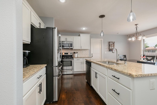 1925 E Costa Mesa Ct, Ozark, MO 65721 - kitchen with appliances with stainless steel finishes, dark wood-type flooring, decorative backsplash, white cabinetry, and hanging light fixtures