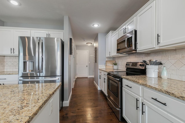 1925 E Costa Mesa Ct, Ozark, MO 65721 - kitchen featuring appliances with stainless steel finishes, white cabinets, dark wood-style floors, decorative backsplash, and recessed lighting