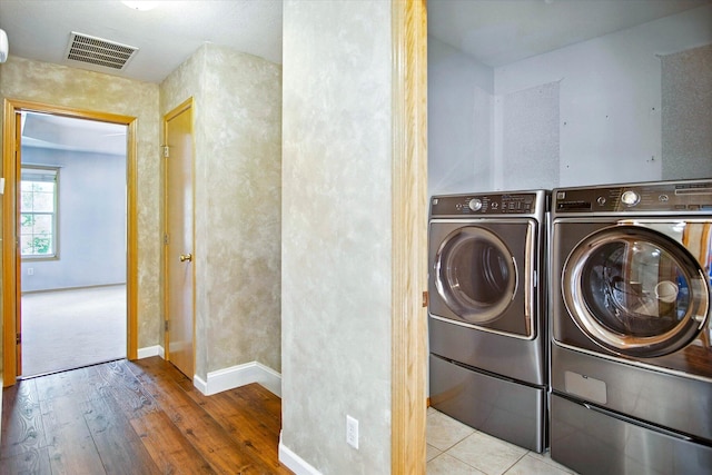 4939 S Prairie View Ave, Battlefield, MO 65619 - laundry room with washing machine and clothes dryer and wood-type flooring