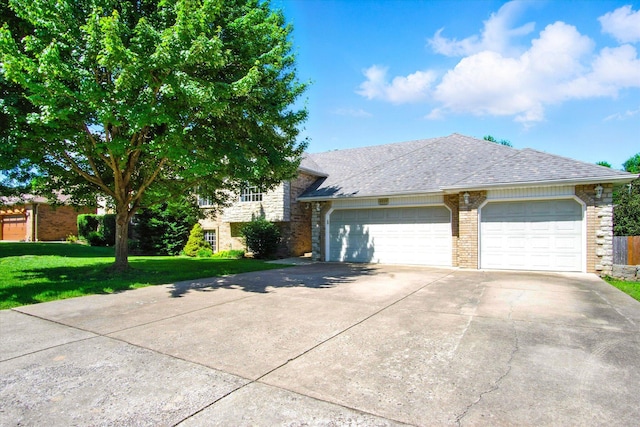 4939 S Prairie View Ave, Battlefield, MO 65619 - view of front facade featuring concrete driveway, a front yard, an attached garage, brick siding, and a shingled roof