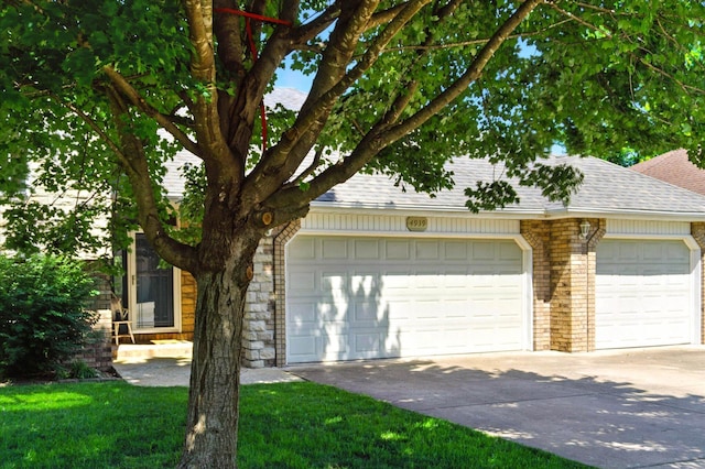 4939 S Prairie View Ave, Battlefield, MO 65619 - view of front of property with roof with shingles, driveway, brick siding, and a garage