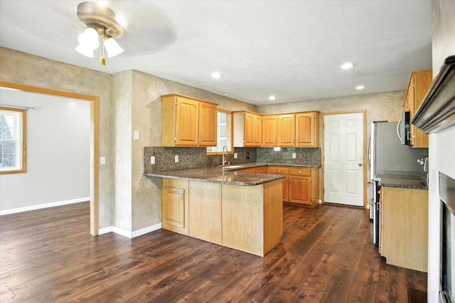 4939 S Prairie View Ave, Battlefield, MO 65619 - kitchen with a peninsula, dark wood-style flooring, decorative backsplash, ceiling fan, and stove