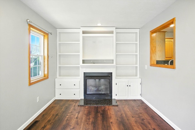 4939 S Prairie View Ave, Battlefield, MO 65619 - unfurnished living room with a glass covered fireplace, dark wood finished floors, and built in shelves