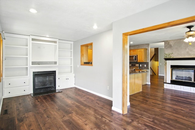 4939 S Prairie View Ave, Battlefield, MO 65619 - unfurnished living room featuring a glass covered fireplace, dark wood-style flooring, recessed lighting, and ceiling fan