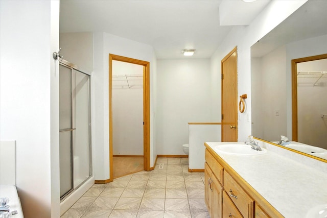 4939 S Prairie View Ave, Battlefield, MO 65619 - full bath with a stall shower, a walk in closet, double vanity, and tile patterned floors