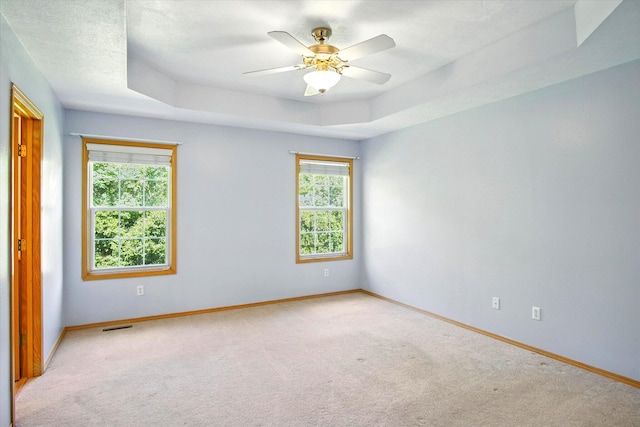 4939 S Prairie View Ave, Battlefield, MO 65619 - empty room with light colored carpet, a raised ceiling, and a ceiling fan
