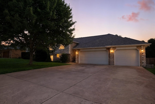 4939 S Prairie View Ave, Battlefield, MO 65619 - view of front facade featuring stone siding, driveway, a garage, and a lawn