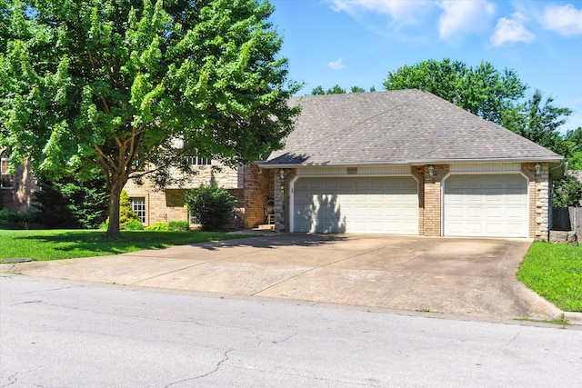 4939 S Prairie View Ave, Battlefield, MO 65619 - view of front of home with brick siding, concrete driveway, a garage, and a shingled roof
