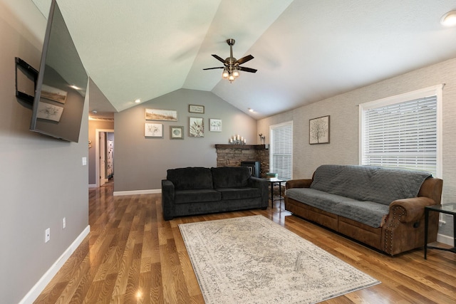 1020 Berkley Dr, Marshfield, MO 65706 - living area with a ceiling fan, a stone fireplace, wood finished floors, and vaulted ceiling