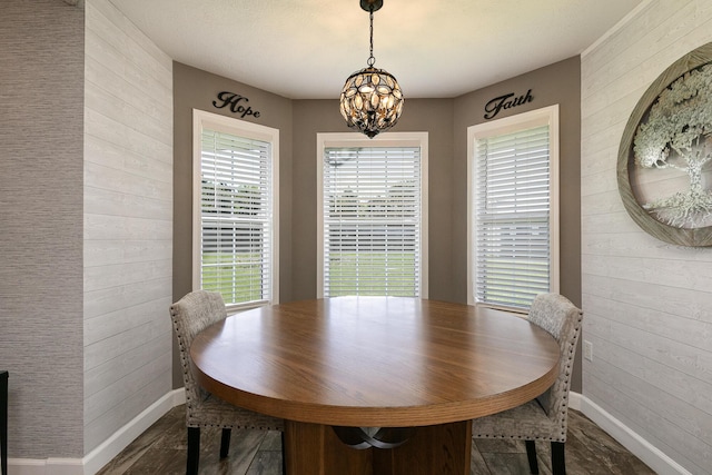 1020 Berkley Dr, Marshfield, MO 65706 - dining room featuring wood walls, a chandelier, and dark wood-style flooring