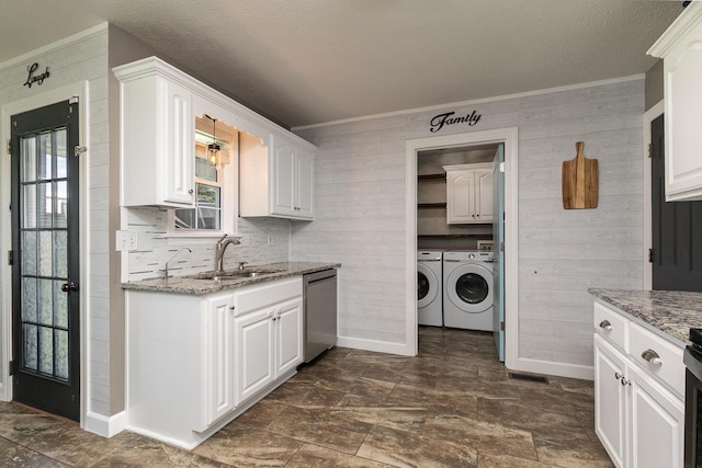 1020 Berkley Dr, Marshfield, MO 65706 - washroom with washing machine and clothes dryer, ornamental molding, cabinet space, dark stone finish flooring, and a textured ceiling