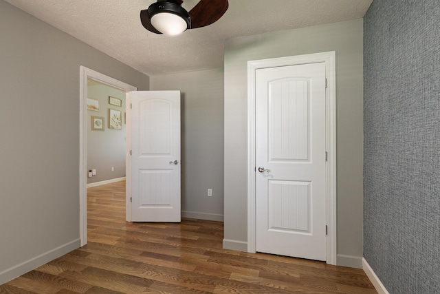 1020 Berkley Dr, Marshfield, MO 65706 - unfurnished bedroom with wood finished floors and a ceiling fan