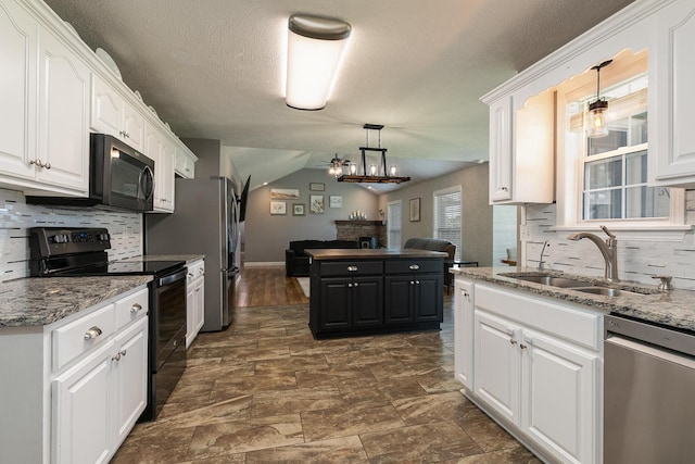 1020 Berkley Dr, Marshfield, MO 65706 - kitchen with appliances with stainless steel finishes, white cabinets, open floor plan, backsplash, and pendant lighting