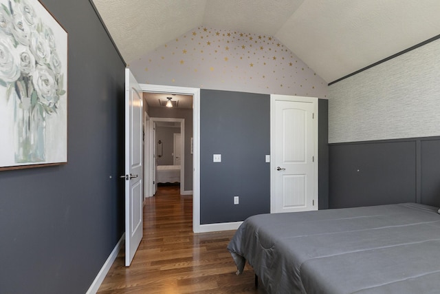 1020 Berkley Dr, Marshfield, MO 65706 - bedroom with vaulted ceiling, wood finished floors, a textured ceiling, and wallpapered walls