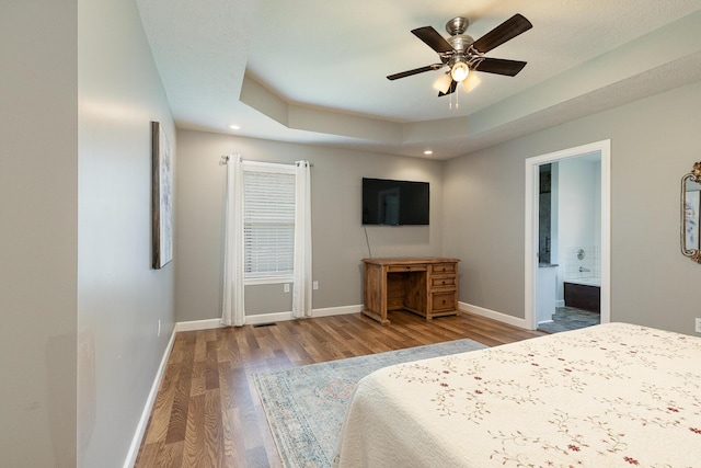 1020 Berkley Dr, Marshfield, MO 65706 - bedroom with wood finished floors, recessed lighting, ensuite bathroom, ceiling fan, and a tray ceiling