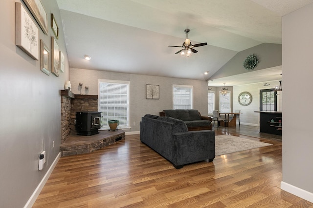 1020 Berkley Dr, Marshfield, MO 65706 - living area with vaulted ceiling, ceiling fan, wood finished floors, and a wood stove