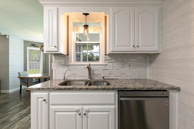 1020 Berkley Dr, Marshfield, MO 65706 - kitchen with stainless steel dishwasher, wood walls, white cabinets, stone counters, and decorative backsplash