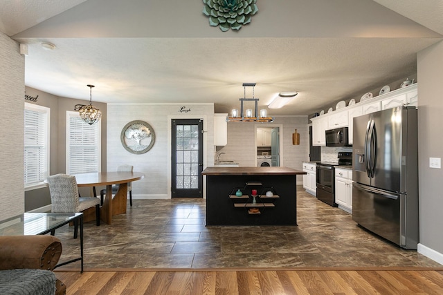 1020 Berkley Dr, Marshfield, MO 65706 - kitchen with black appliances, a chandelier, white cabinetry, washer / clothes dryer, and dark wood-style floors