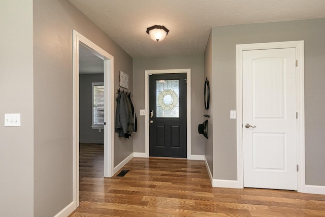 1020 Berkley Dr, Marshfield, MO 65706 - entrance foyer featuring light wood finished floors and a textured ceiling