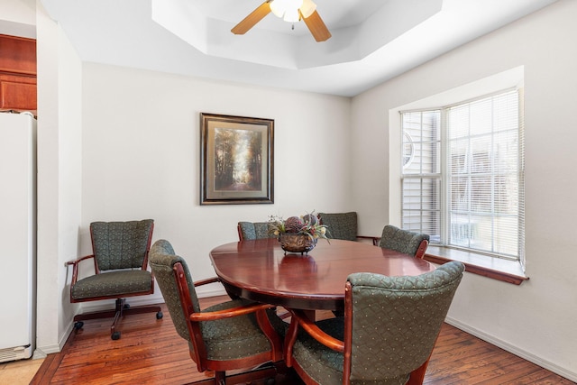300 Glory Rd Unit 2, Branson, MO 65616 - dining space with wood finished floors, a ceiling fan, and a tray ceiling