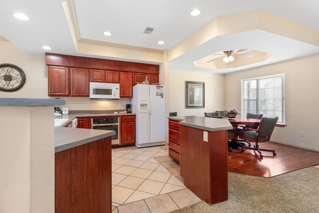 300 Glory Rd Unit 2, Branson, MO 65616 - kitchen with white appliances, a raised ceiling, ceiling fan, recessed lighting, and a kitchen island