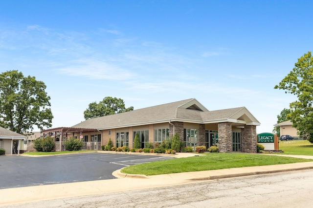300 Glory Rd Unit 2, Branson, MO 65616 - view of front of house featuring uncovered parking, stone siding, a front lawn, and a shingled roof