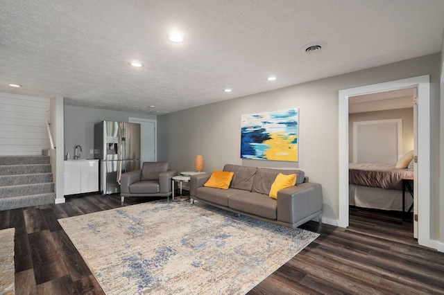 199 Cardinal Rd, Hollister, MO 65672 - living area with dark wood-style floors, stairs, recessed lighting, and a textured ceiling