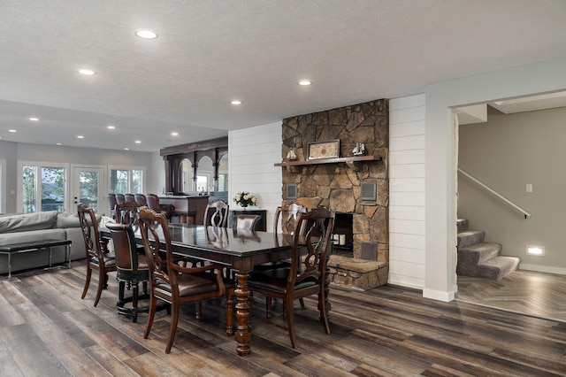 199 Cardinal Rd, Hollister, MO 65672 - dining room featuring wood finished floors, a textured ceiling, stairs, recessed lighting, and a fireplace
