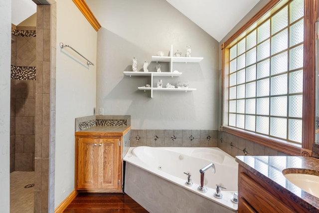 2661 E Ridgewood Dr, Springfield, MO 65804 - full bathroom featuring two vanities, a jetted tub, lofted ceiling, wood finished floors, and a tile shower