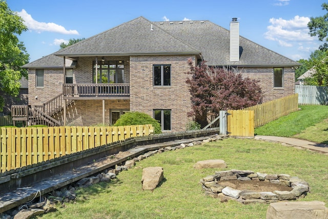 2661 E Ridgewood Dr, Springfield, MO 65804 - rear view of house with brick siding, an outdoor fire pit, a fenced backyard, a chimney, and roof with shingles