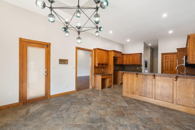 2661 E Ridgewood Dr, Springfield, MO 65804 - kitchen featuring a peninsula, backsplash, dark stone finish floors, dark countertops, and a chandelier