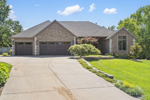 2661 E Ridgewood Dr, Springfield, MO 65804 - view of front of house featuring driveway, an attached garage, brick siding, and a shingled roof
