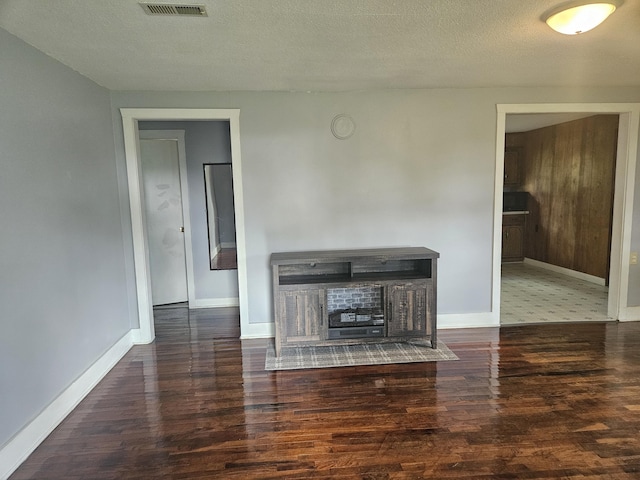 1713 Wall Rd, Mountain Grove, MO 65711 - unfurnished living room with wood finished floors and a textured ceiling