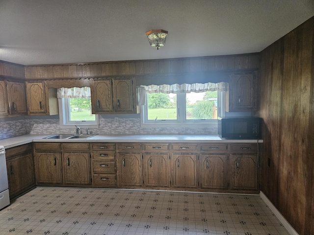 1713 Wall Rd, Mountain Grove, MO 65711 - kitchen featuring black microwave, light countertops, light floors, backsplash, and a textured ceiling