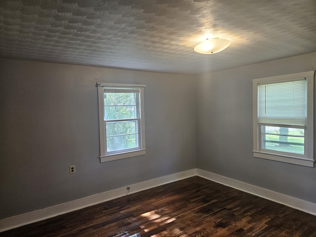 1713 Wall Rd, Mountain Grove, MO 65711 - spare room with dark wood finished floors and a textured ceiling