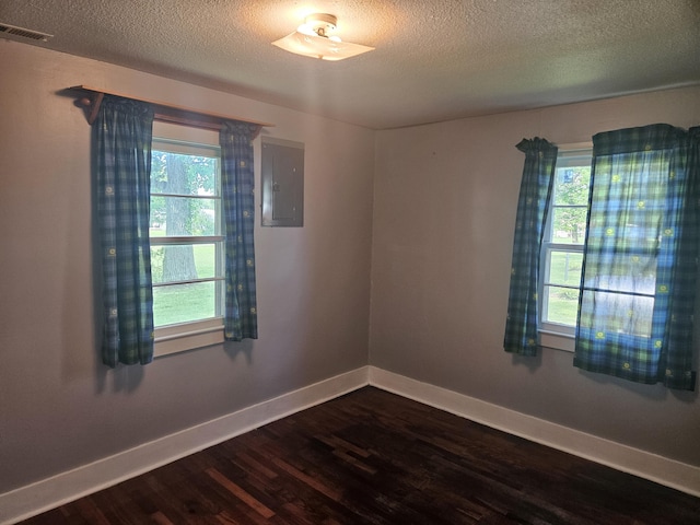 1713 Wall Rd, Mountain Grove, MO 65711 - empty room with electric panel, dark wood-type flooring, and a textured ceiling