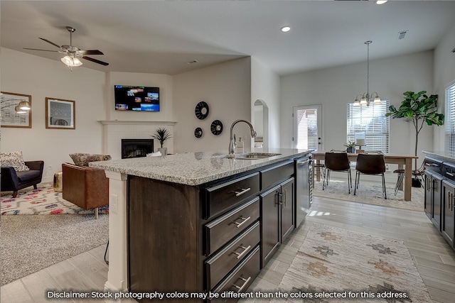 703 N Baywood Dr, Nixa, MO 65714 - kitchen featuring open floor plan, light wood-type flooring, dishwasher, a tile fireplace, and recessed lighting