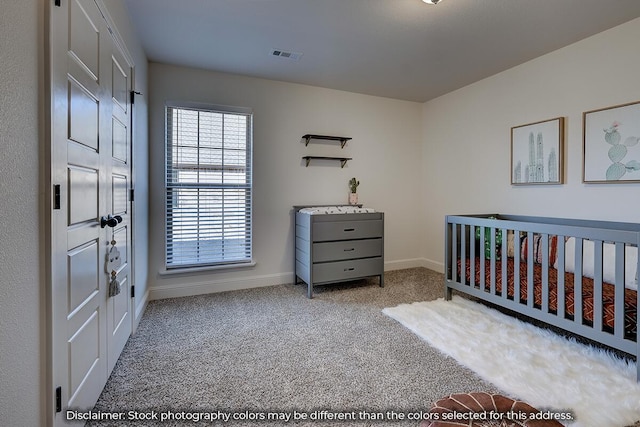 703 N Baywood Dr, Nixa, MO 65714 - carpeted bedroom with baseboards and a crib