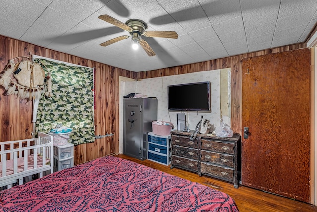1215 Lanton Rd, West Plains, MO 65775 - bedroom with wood walls, wood finished floors, and ceiling fan