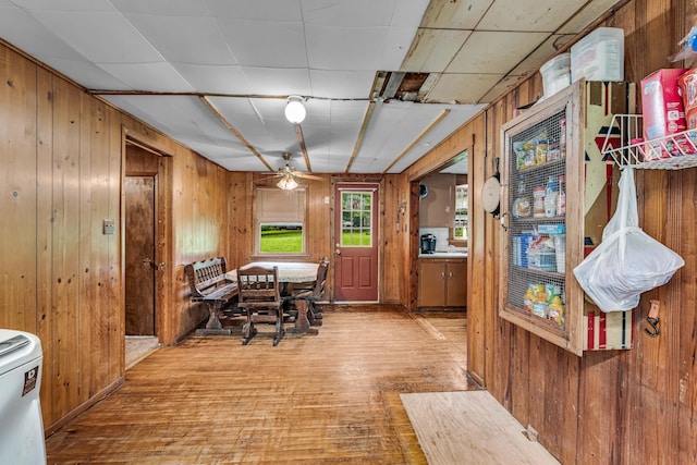 1215 Lanton Rd, West Plains, MO 65775 - dining space featuring wood walls, ceiling fan, and wood finished floors