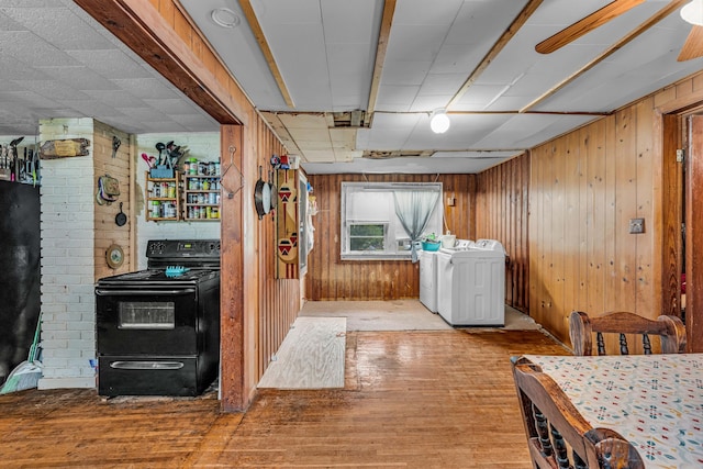 1215 Lanton Rd, West Plains, MO 65775 - laundry area with wood finished floors, washer / dryer, and wooden walls