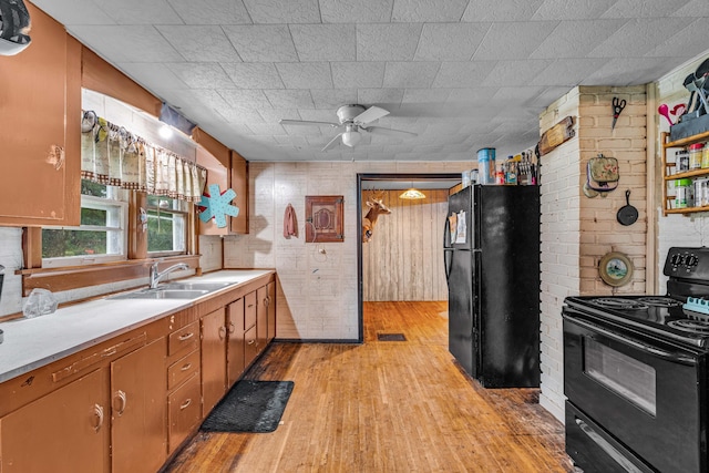 1215 Lanton Rd, West Plains, MO 65775 - kitchen with black appliances, light wood-style floors, a ceiling fan, light countertops, and brown cabinetry