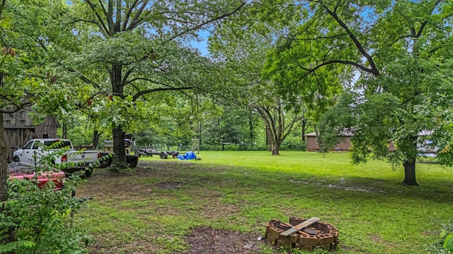 1215 Lanton Rd, West Plains, MO 65775 - view of grassy yard featuring an outdoor fire pit