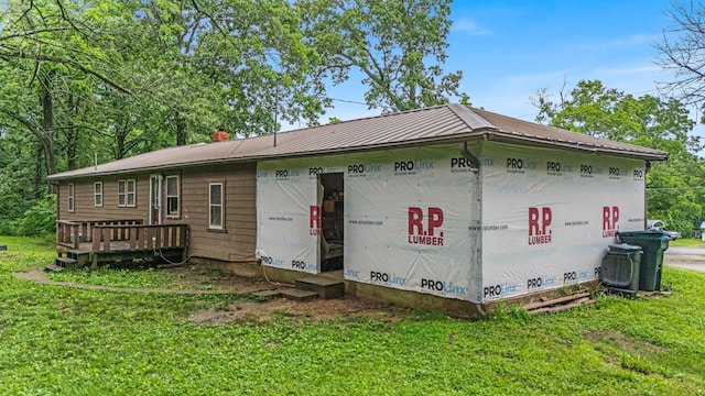 1215 Lanton Rd, West Plains, MO 65775 - rear view of house featuring a lawn, a metal roof, and a chimney