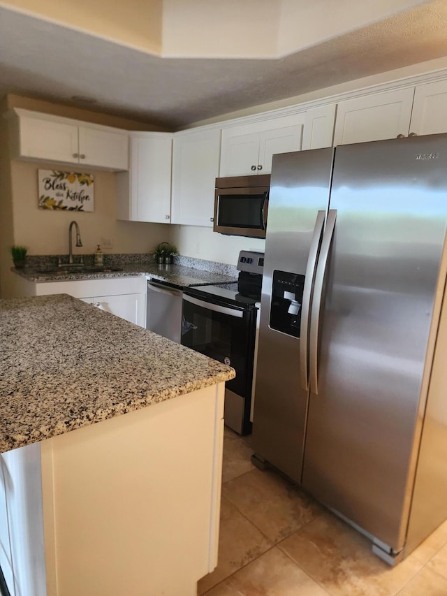 180 Grace Chapel Rd Unit 228, Blue Eye, MO 65611 - kitchen with stainless steel appliances, white cabinetry, light tile patterned floors, and light stone countertops