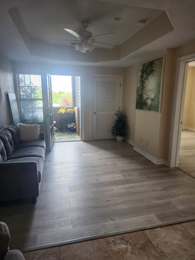 180 Grace Chapel Rd Unit 228, Blue Eye, MO 65611 - living room featuring a raised ceiling, ceiling fan, and wood finished floors